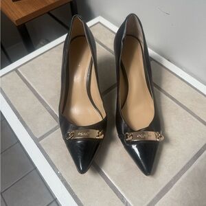 Coach Leather heels with patent, shiny toe tips.